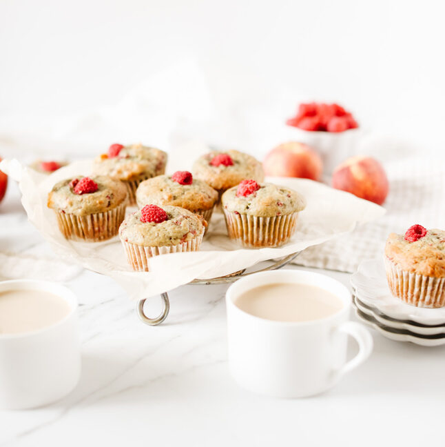 fraiche living raspberry peach muffins on plate with cup of coffee