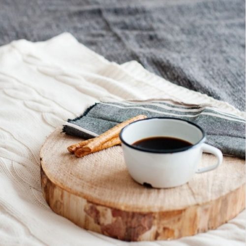 cup of coffee on wooden coaster