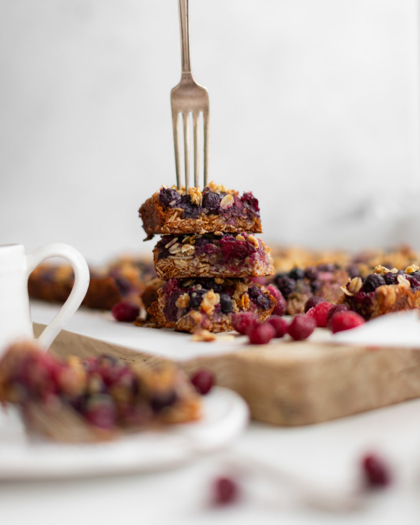 a silver fork in a stack of homemade almond berry breakfast bars 