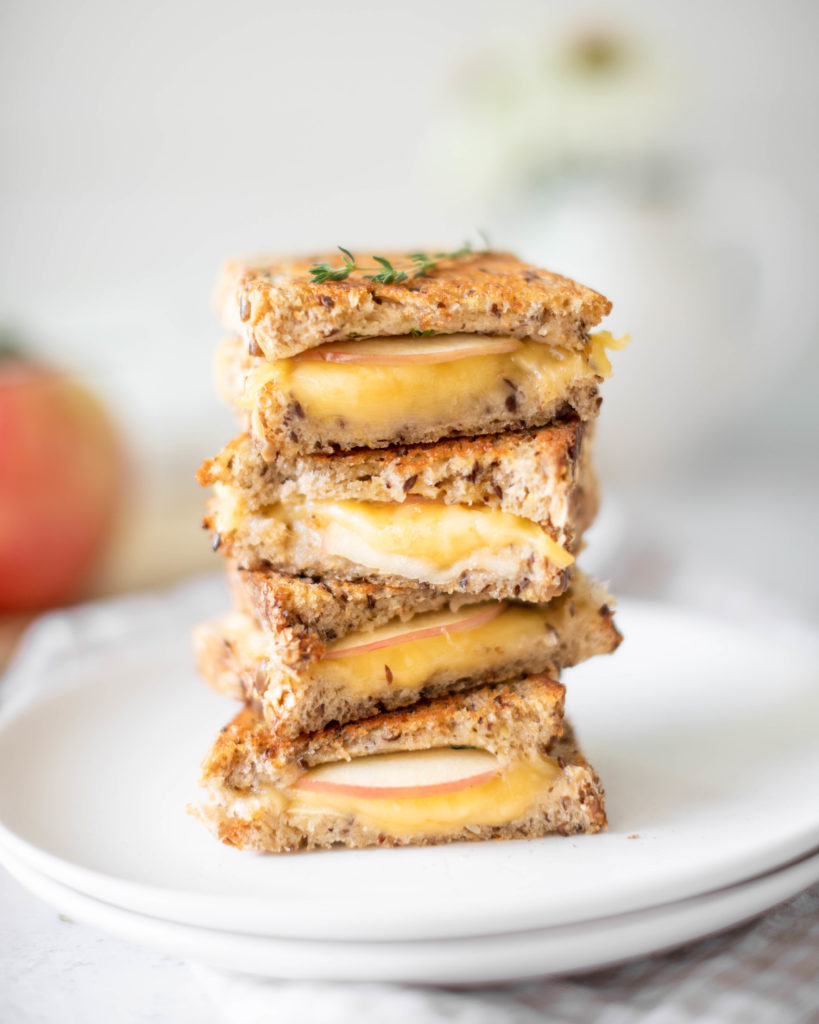 Gouda, Thyme & Apple Grilled Cheese stacked on a plate