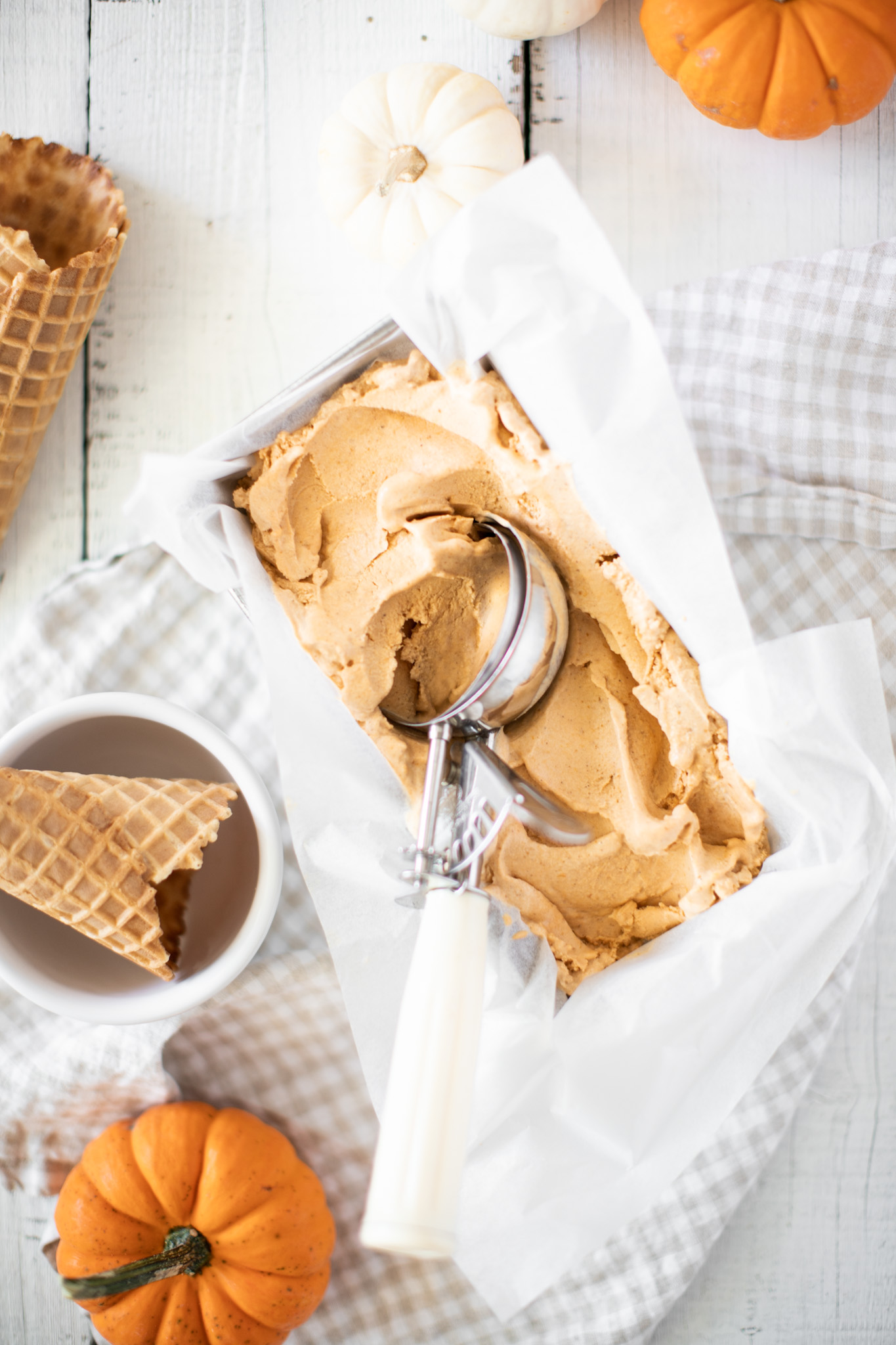 Pumpkin Pie Ice Cream with a scoop and waffle cones
