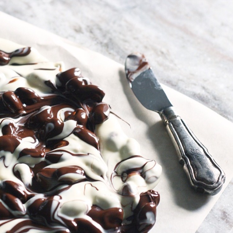 Marble almond bark on white platter with silver knife