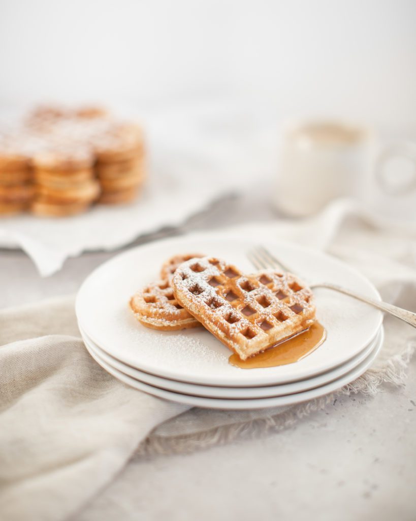 heart-shaped  ggnog waffle with syrup