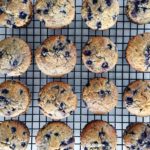 lemon blueberry oat bran muffins arranged in 4 columns of 4 on a cooling rack