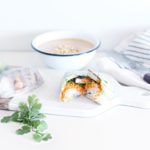 crispy tofu salad rolls on a white serving board with a bowl of soup