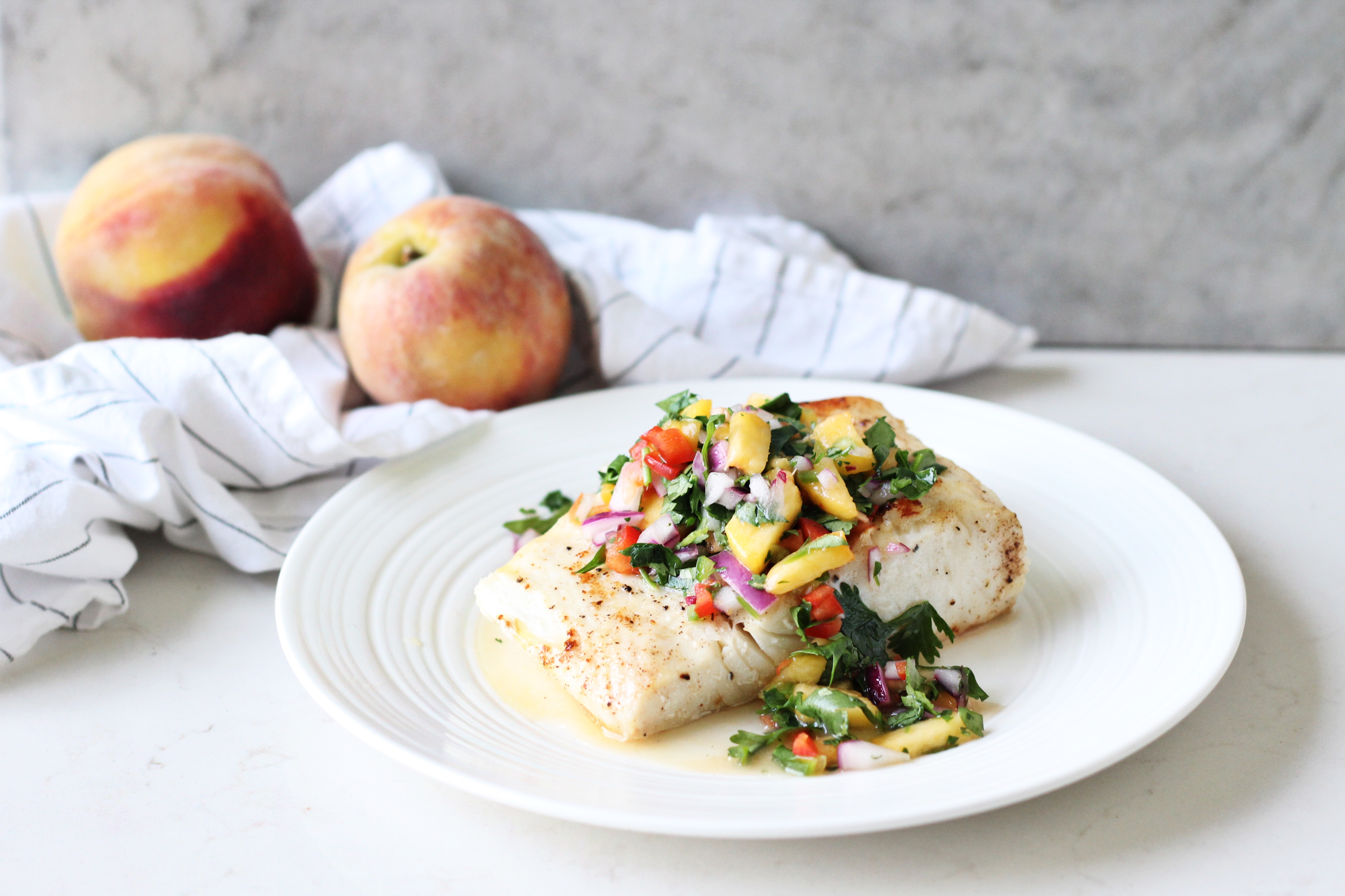 Halibut with Mango Salsa & Coconut Rice on white plate