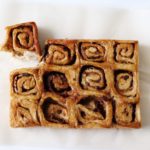 apple honey whole wheat cinnamon buns fresh out of the oven on a white background
