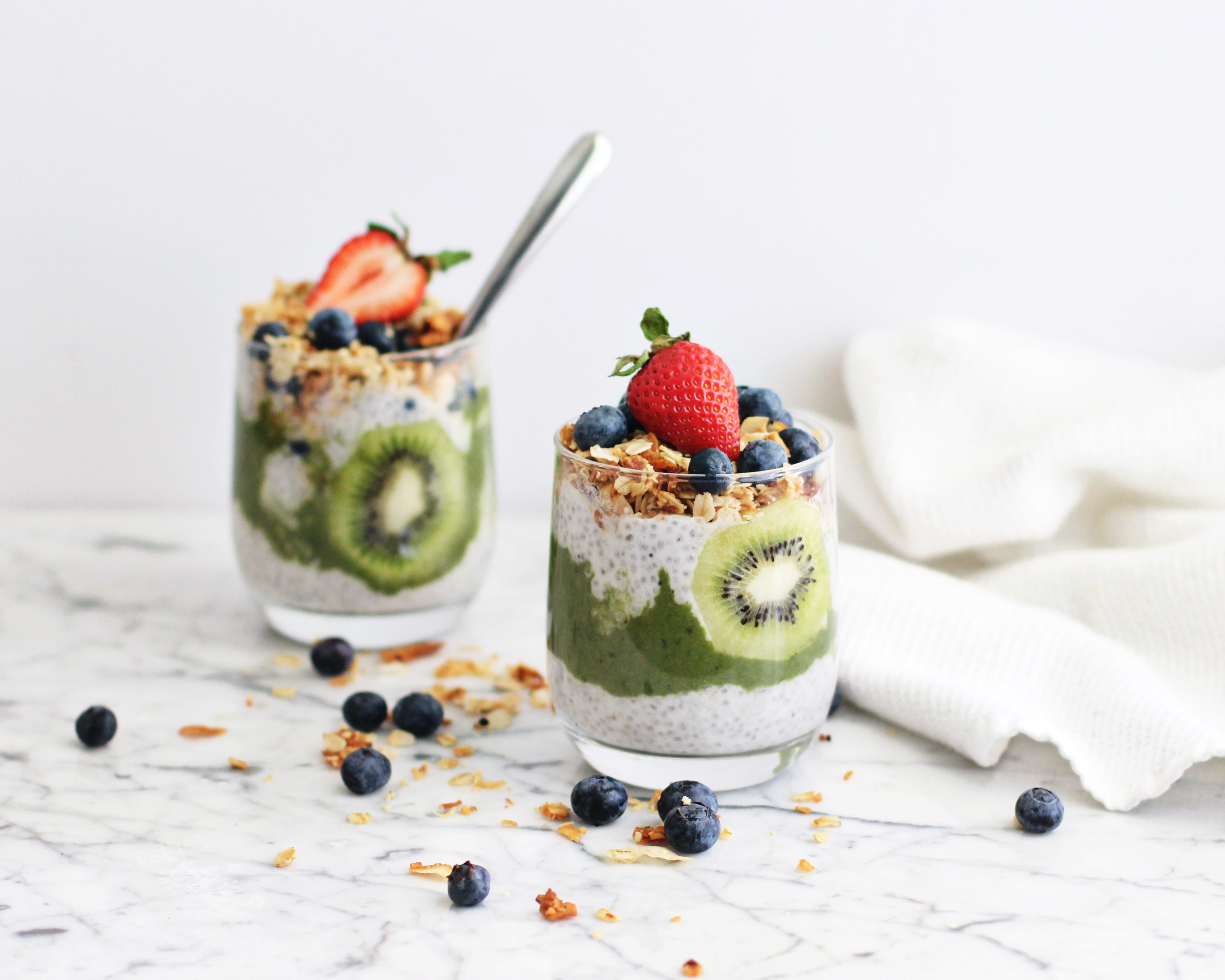 Tropical Green Chia Pudding with Coconut Crunch, kiwi, blueberries and strawberries 