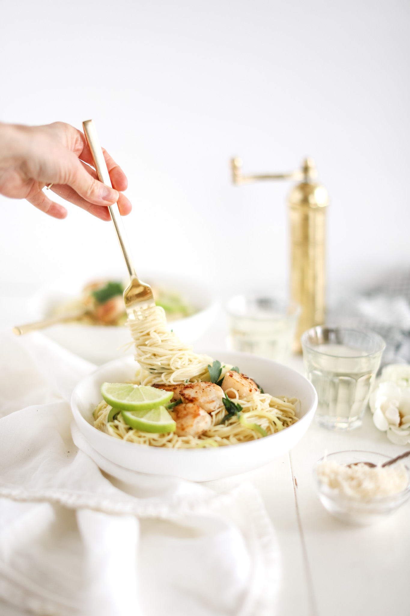 Lime capellini pasta twirled on a fork