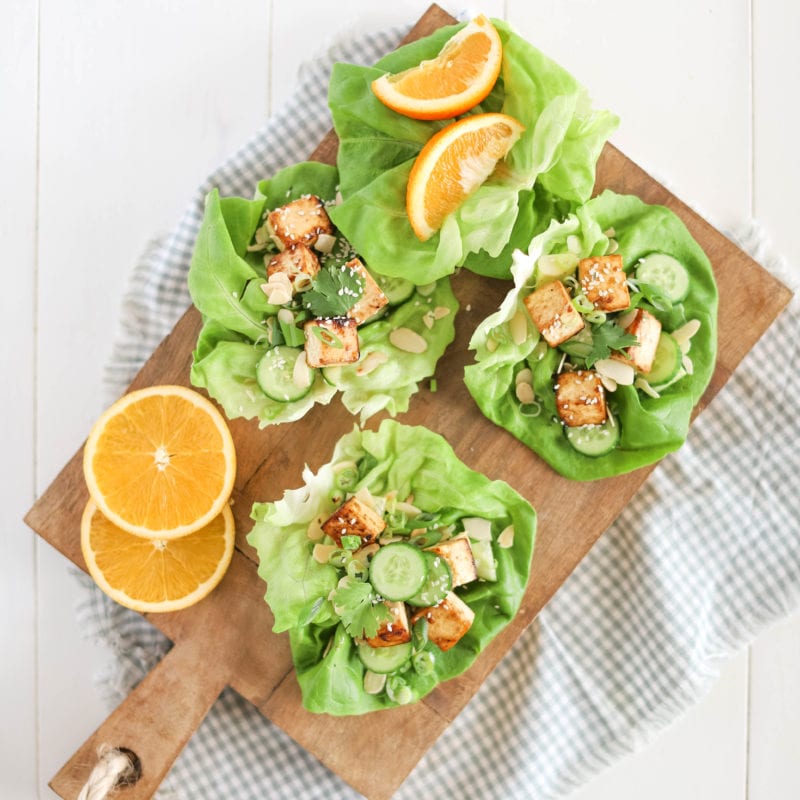 orange tofu lettuce wraps on cutting board