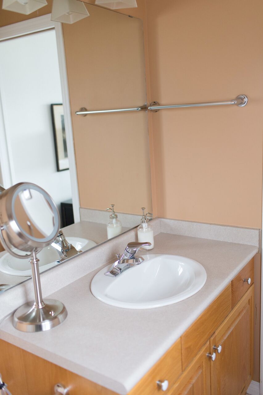 Oak cabinet vanity with white sink in bathroom 