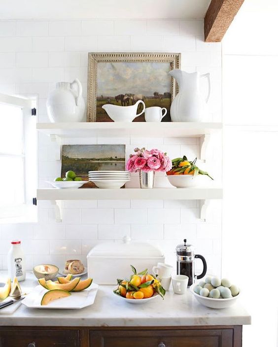 open shelves with white ware, fresh flowers, antique pictures 