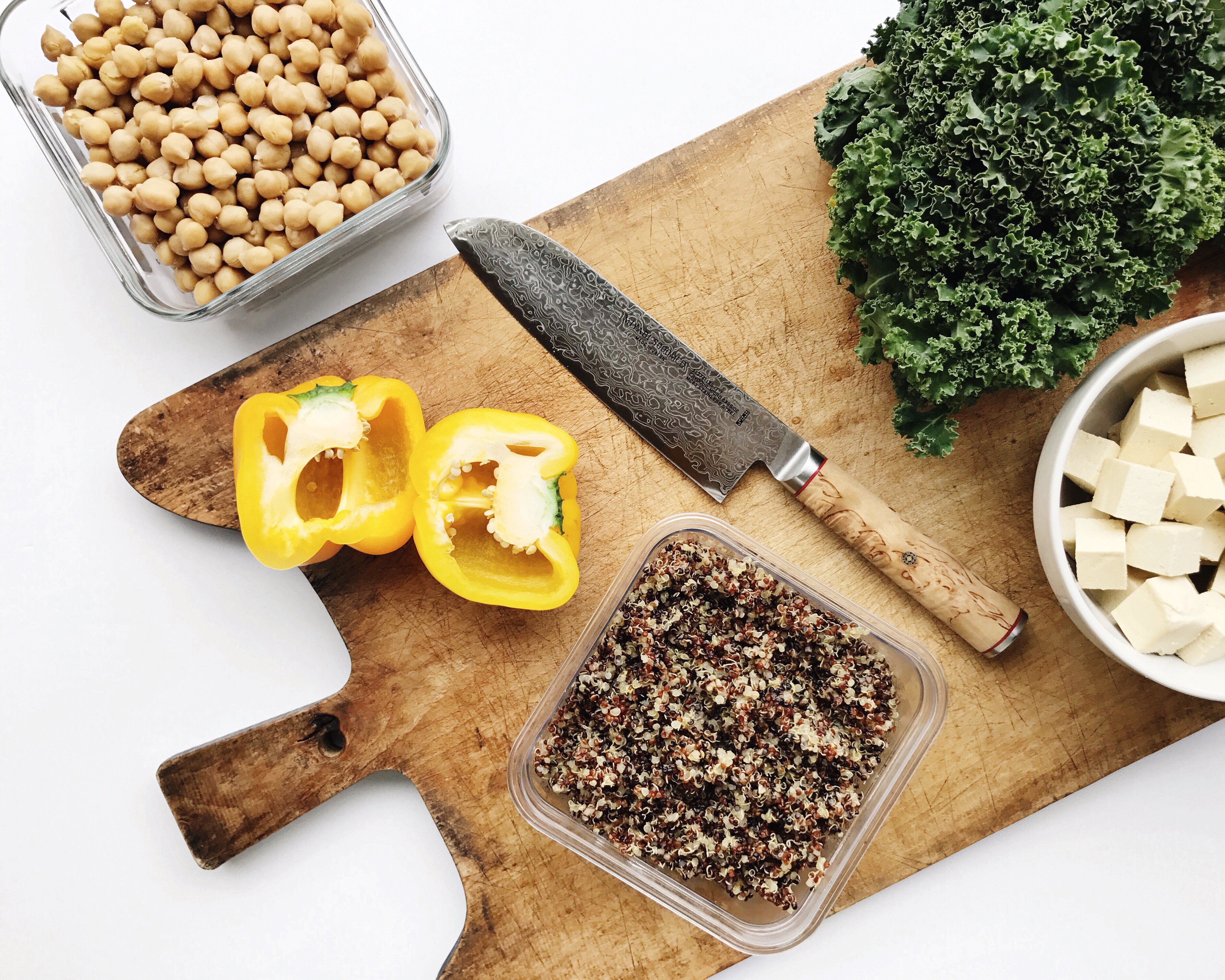 chickpeas, kale, yellow peppers, tofu on cutting board 