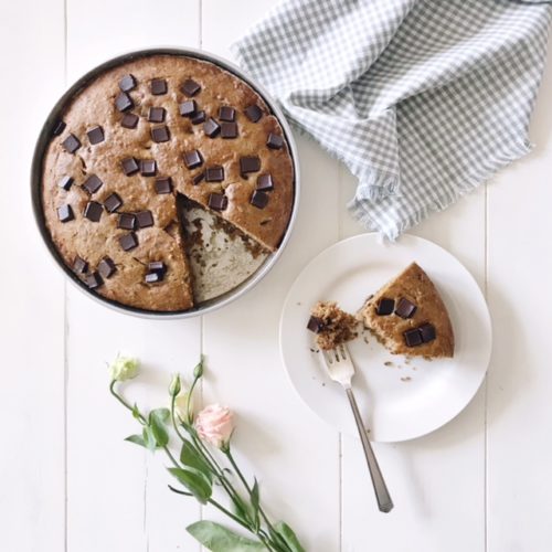 Chocolate Chunk Olive Oil Banana Cake with Lisianthus Flowers, a vintage fork and a Gingham napkin on a white farmhouse table