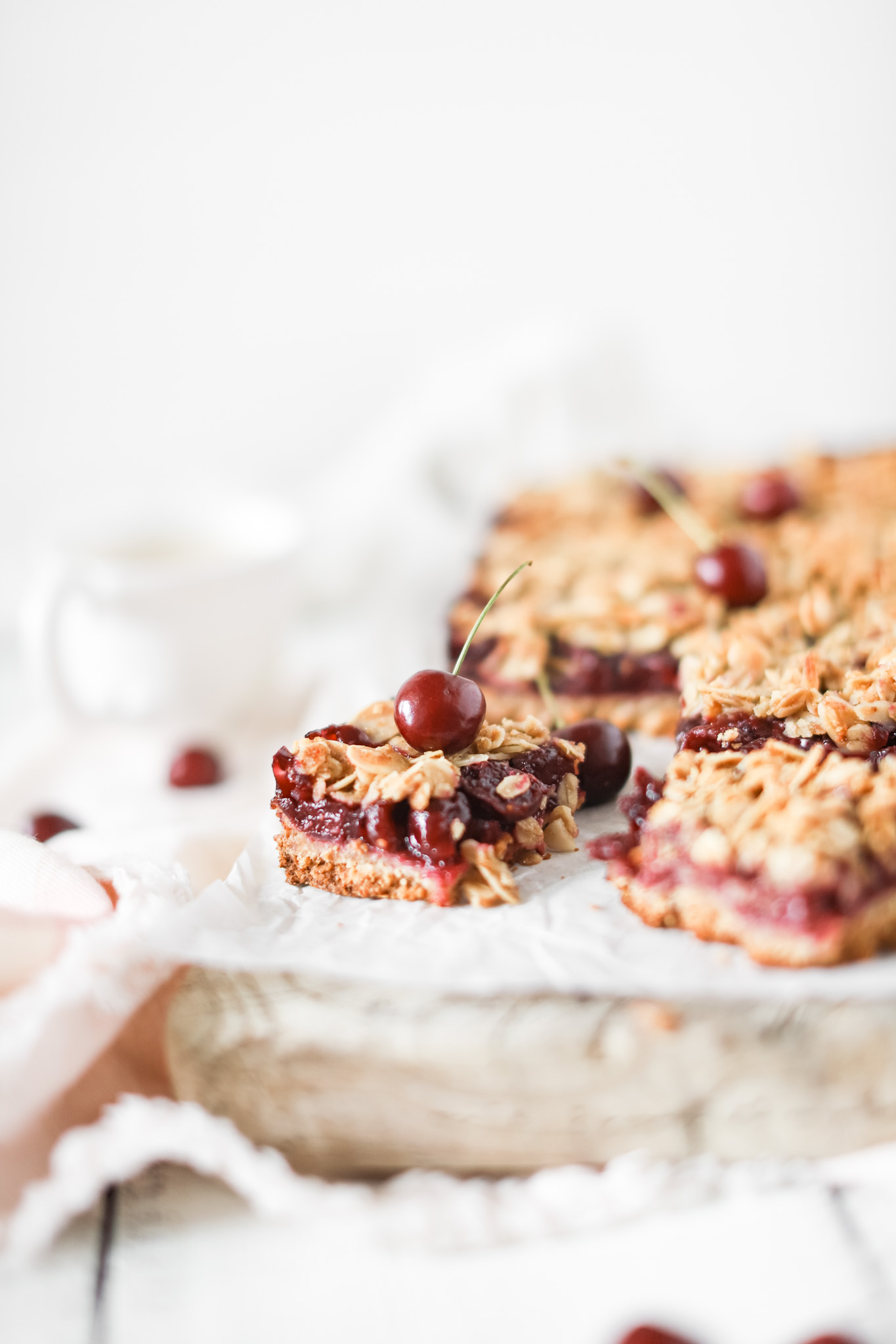 Okanagan Cherry Oat Bars cut into squares with a cherry on top