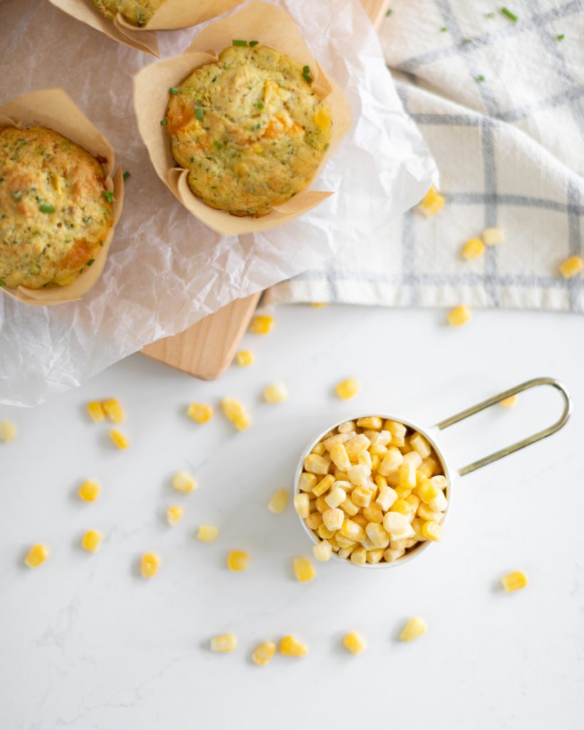 veggie muffins with a cup of frozen corn