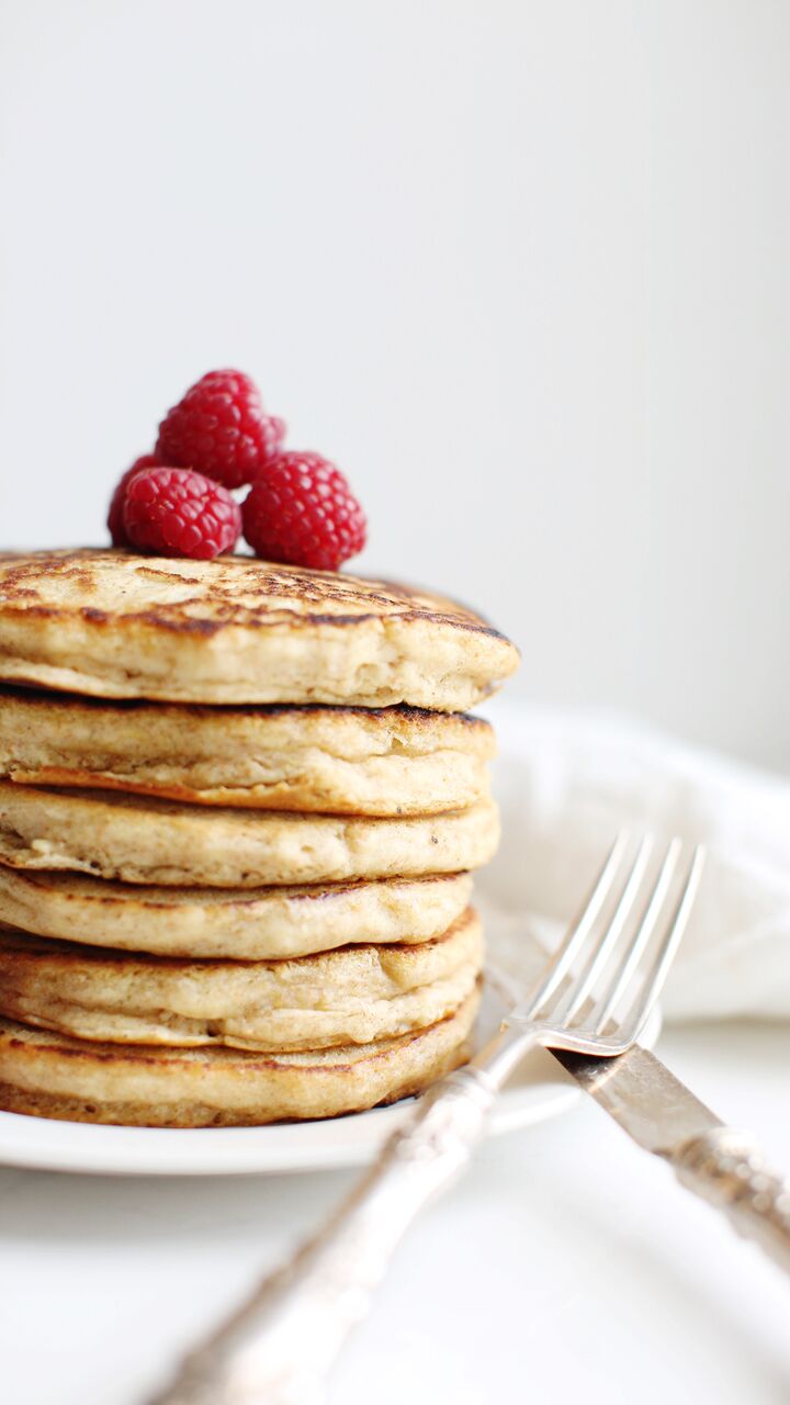 The BEST fluffy vegan pancakes made with whole wheat flour and piled high with fresh berries.
