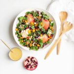 Confetti Kale Salad filled with seasonal winter ingredients including pomegranates, crisp apples, shredded red cabbage, kale, roasted squash and almonds - completely gluten free and vegan.