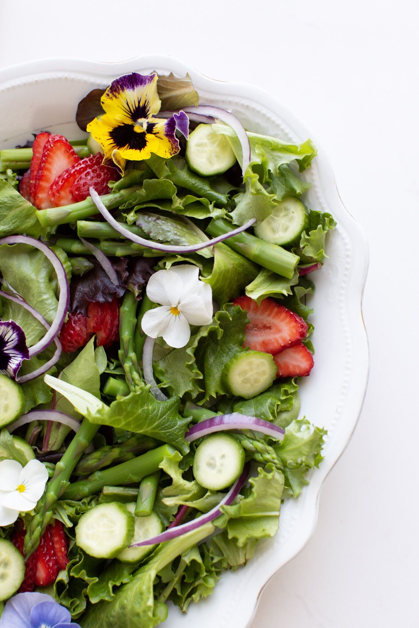 Spring Salad with edible flowers and creamy lemon vinaigrette.