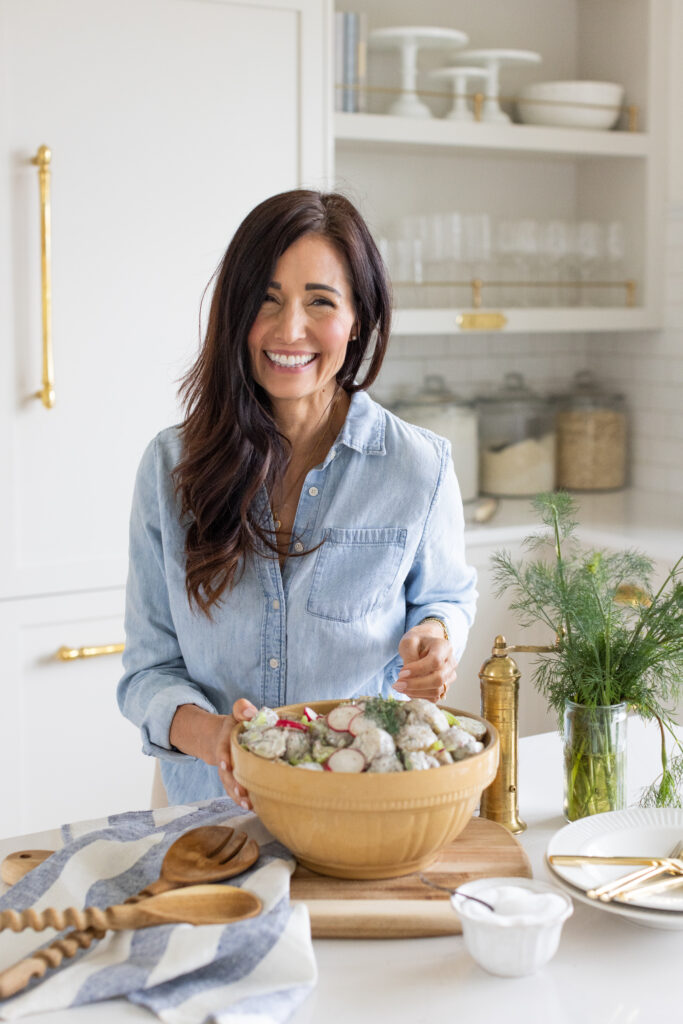 Tori with a bowl of creamy dill potato salad made with baby potatoes, radish and fresh dill