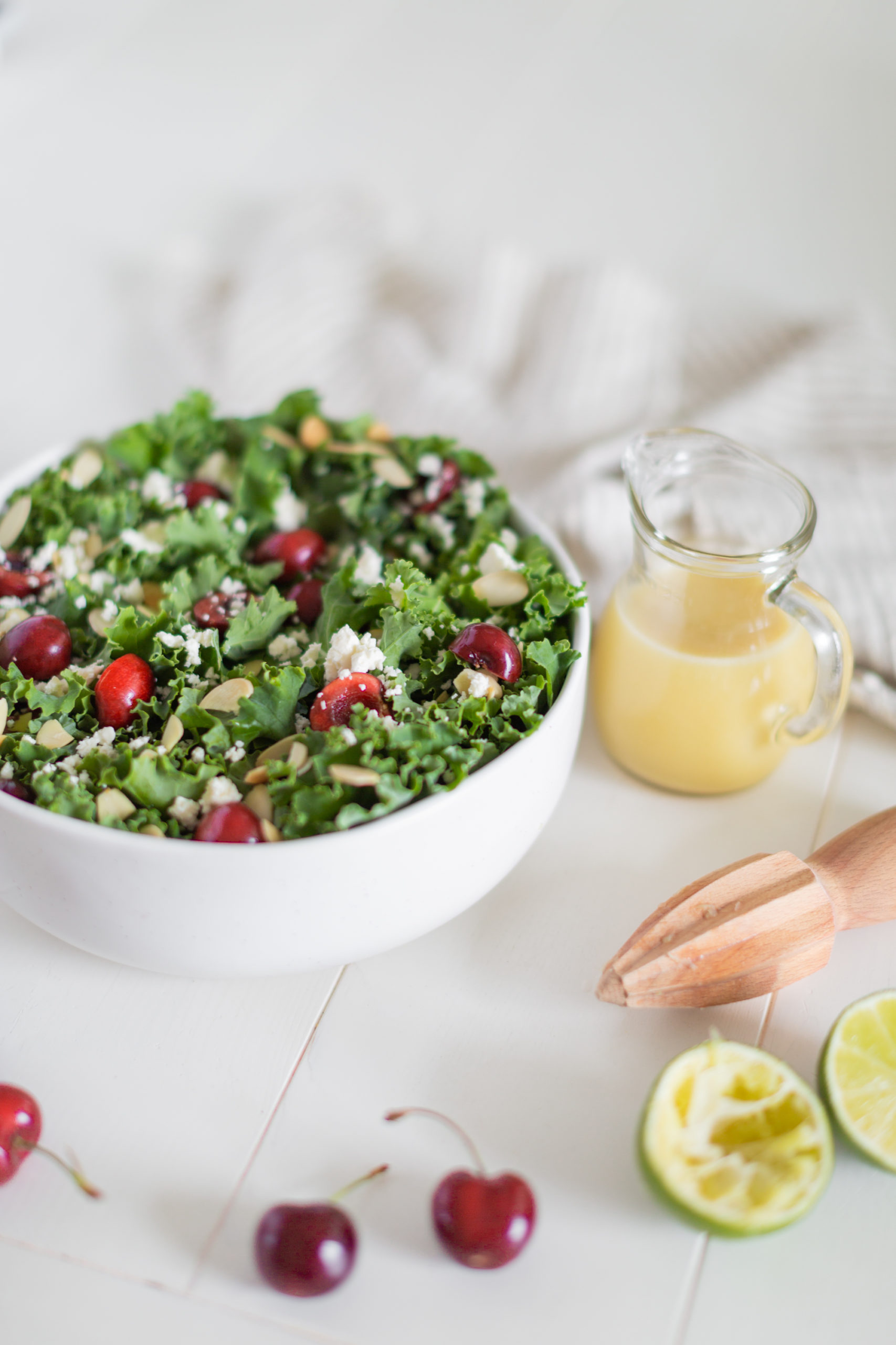 Okanagan Kale Salad loaded with fresh cherries, feta cheese and toasted almonds with a light honey lime vinaigrette