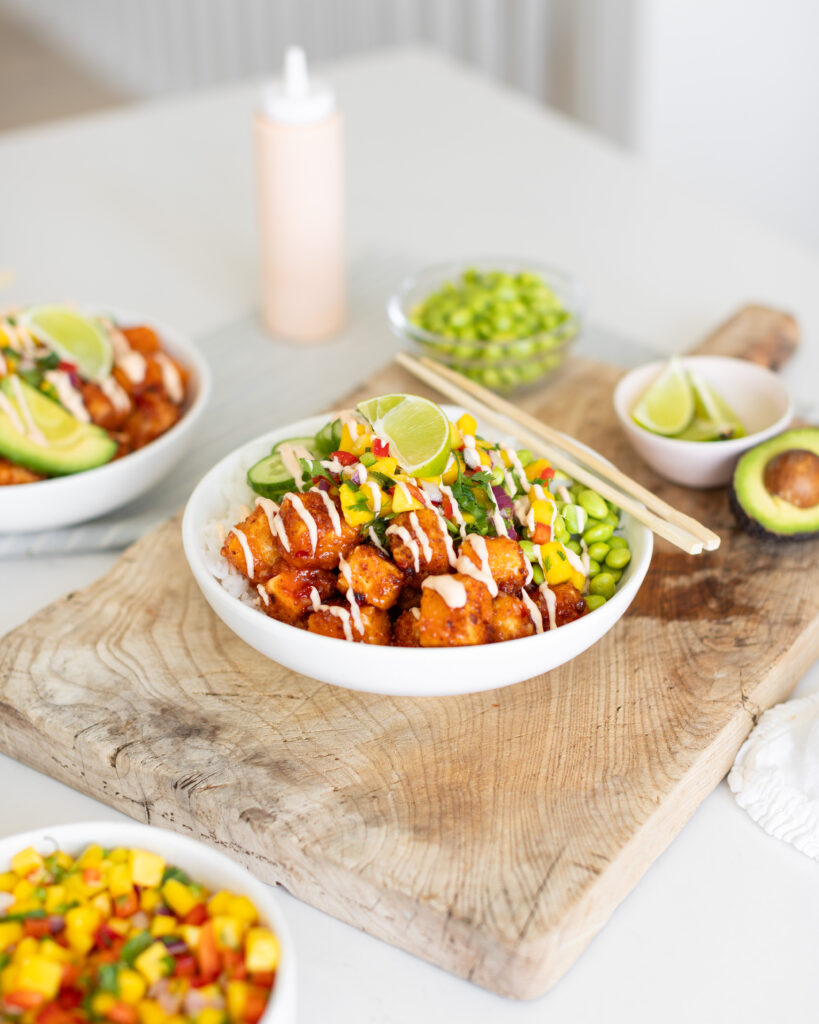 Crispy Tofu Bowl with mango salsa, cucumber, edamame, on rice with a drizzle of spicy mayo