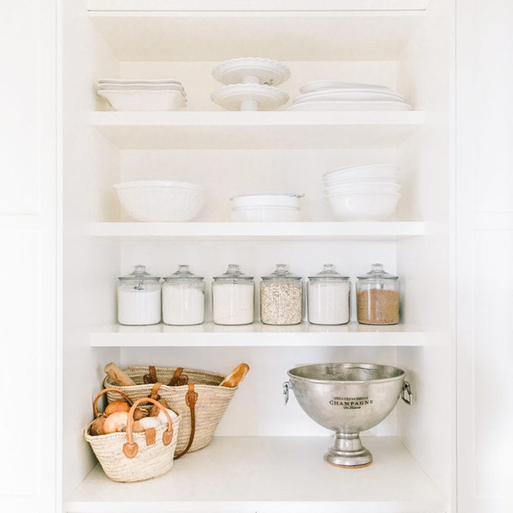 Our Butler Pantry reveal complete with all of the sources, my favourite must-have features and how we keep our pantry organized, functional and beautiful! I love the arched entryway, vintage brass chandelier and open white shelving!
