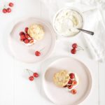 cherry almond shortcakes plated with red cherries and whipped cream on Fable blush pink plates