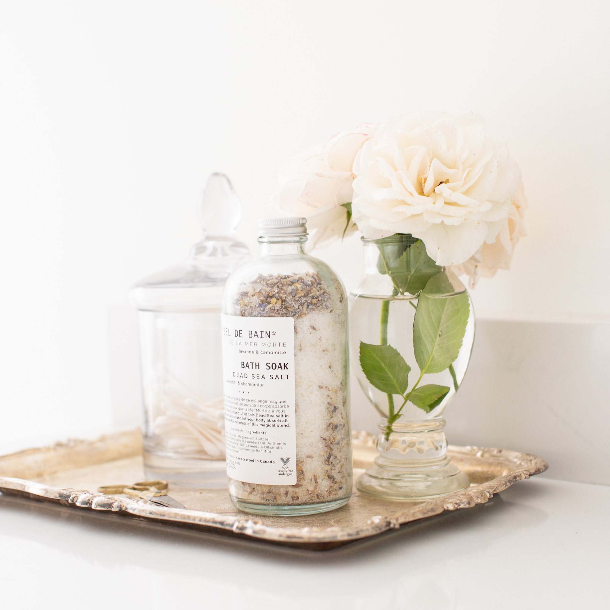 flowers and bath salts on a vintage tray