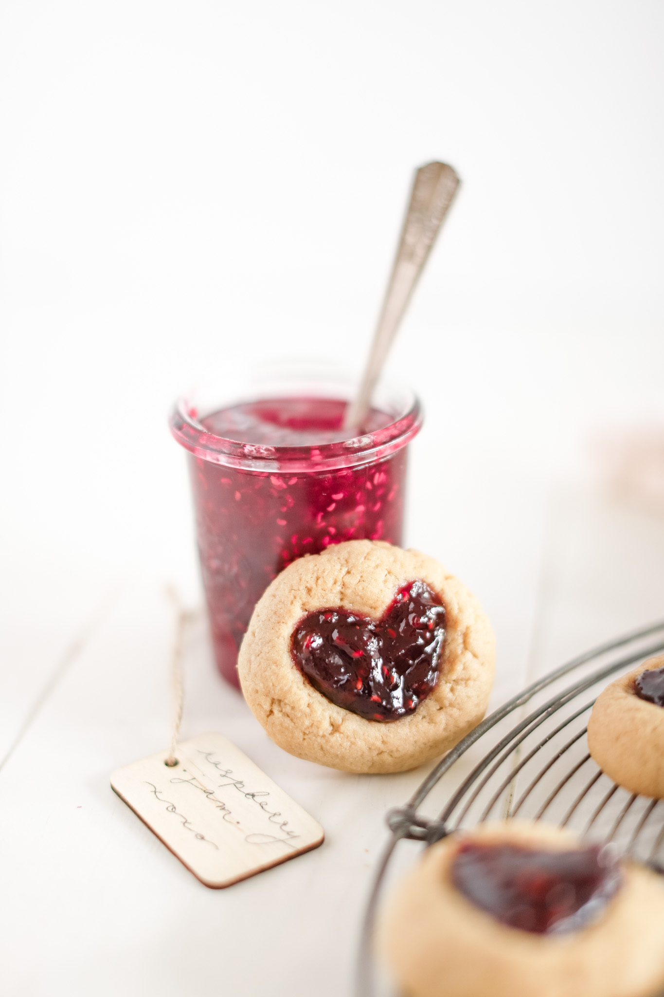 jam thumbprint cookie beside jar of jam