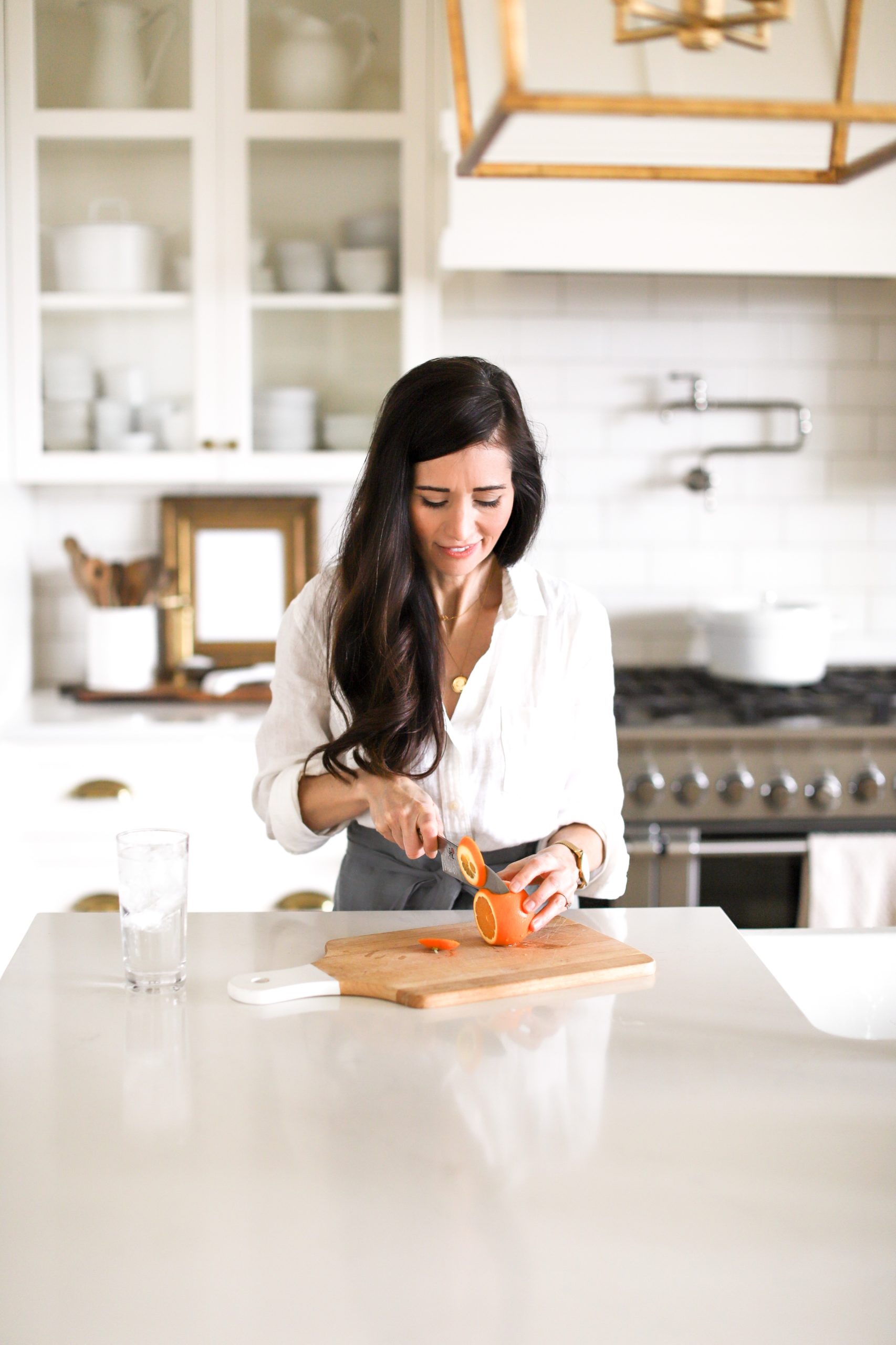 woman cutting up orange slices