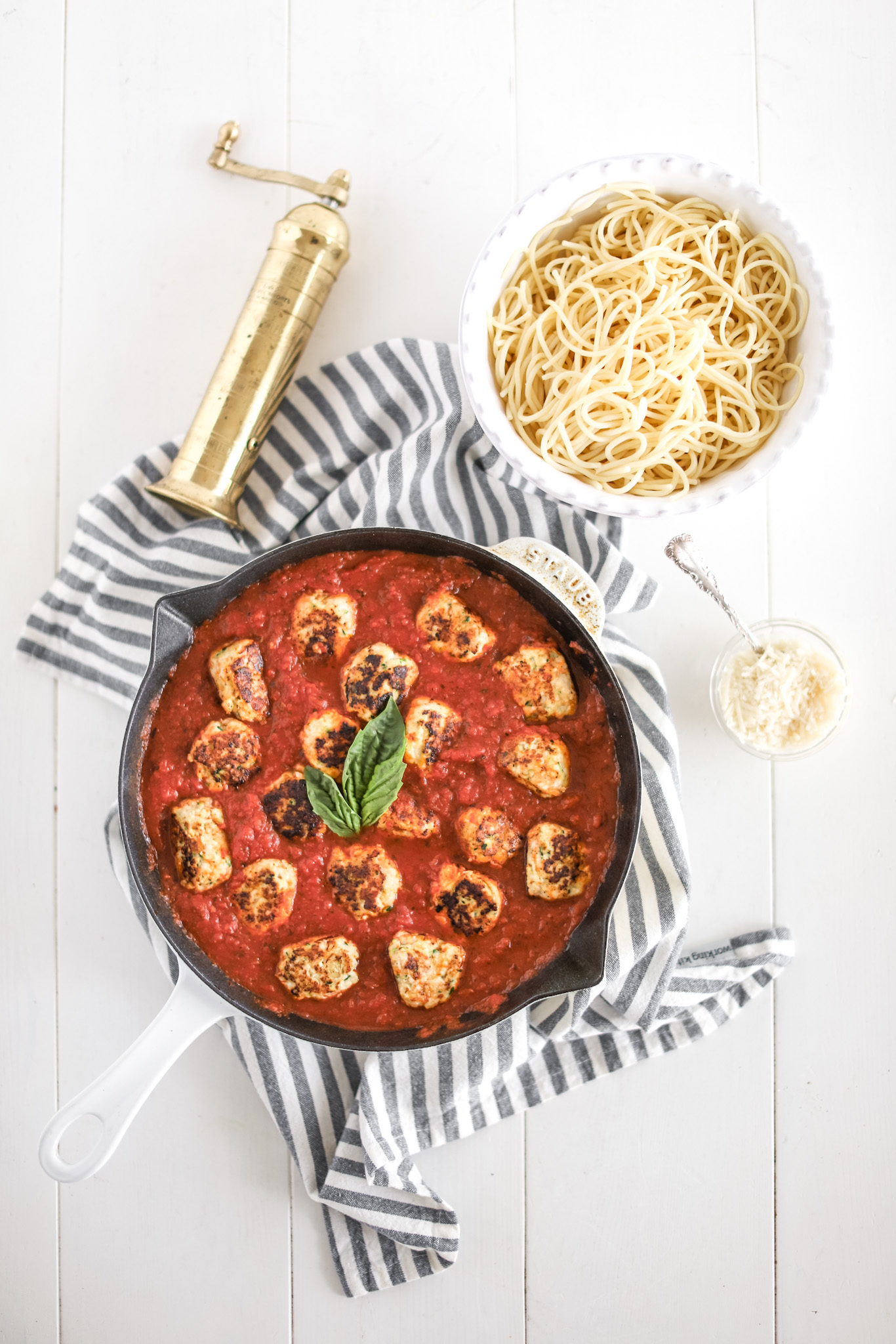 sneaky mommy meatballs in a skillet with tomato sauce