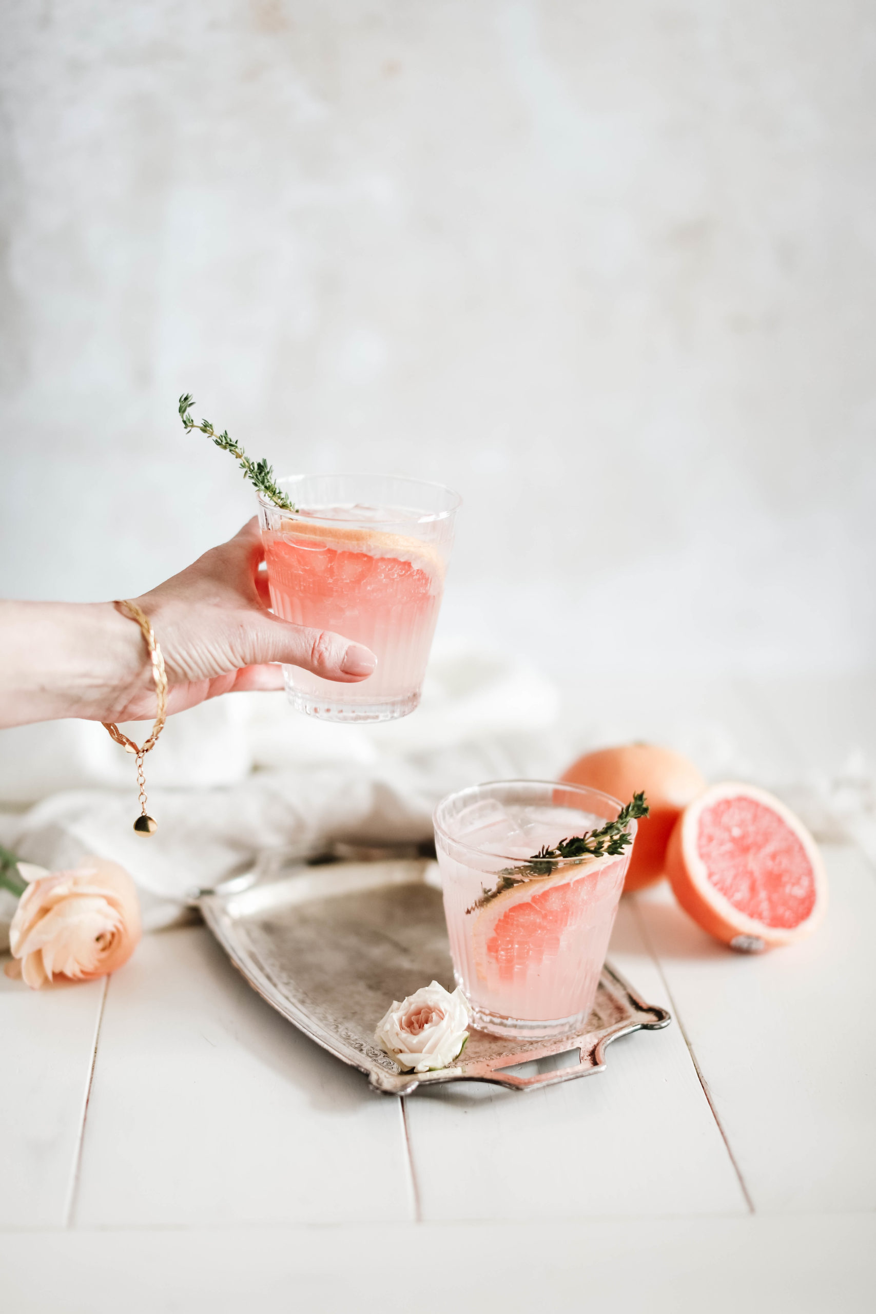 pink grapefruit Paloma cocktails with sprigs of thyme