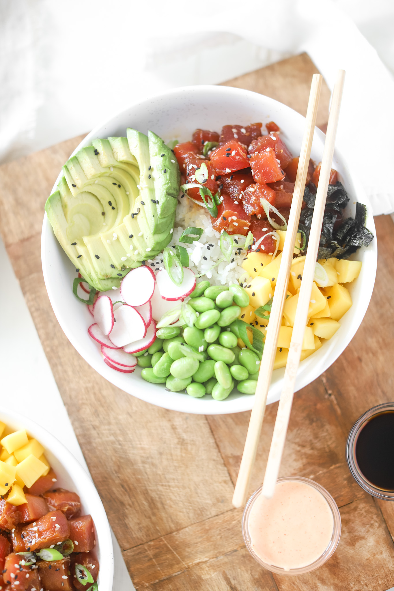 Closeup of Tuna Poke Bowl with avocado, tuna, edamame, radishes and mango