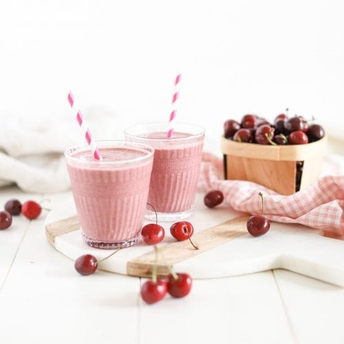 cherry amaretto smoothie in two glasses with straws