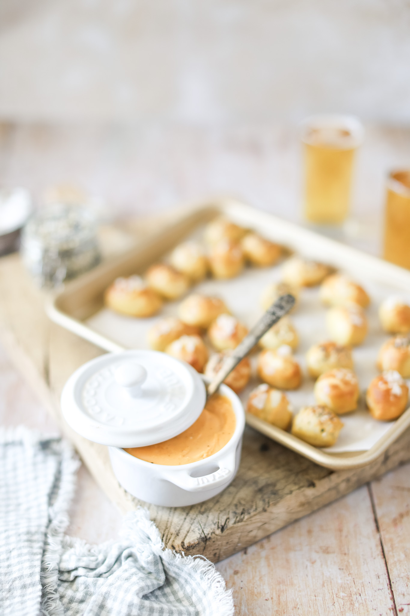 Soft Pretzel Bites on a tray and Beer Cheese Dip in a bowl with spoon