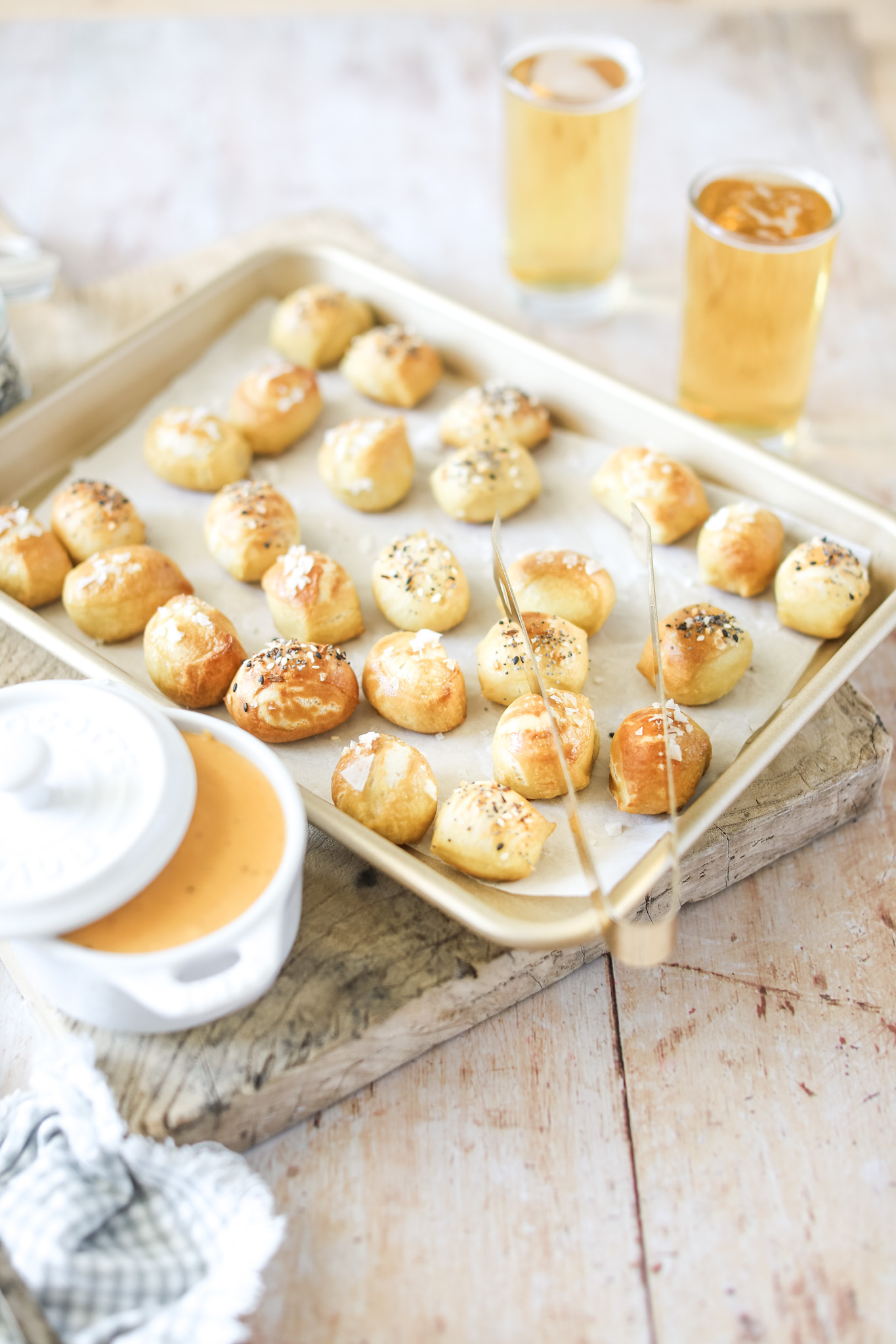 Soft Pretzel Bites and Beer Cheese Dip on a tray with glasses of beer