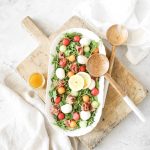 prosciutto melon salad fraiche living in bowl with serving spoons and vinaigrette