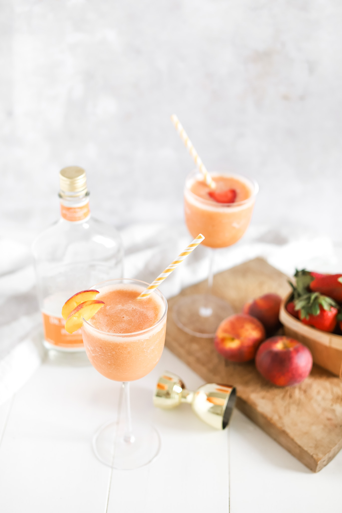 Okanagan Peach Bellini Fraiche Living in two glasses with straws
