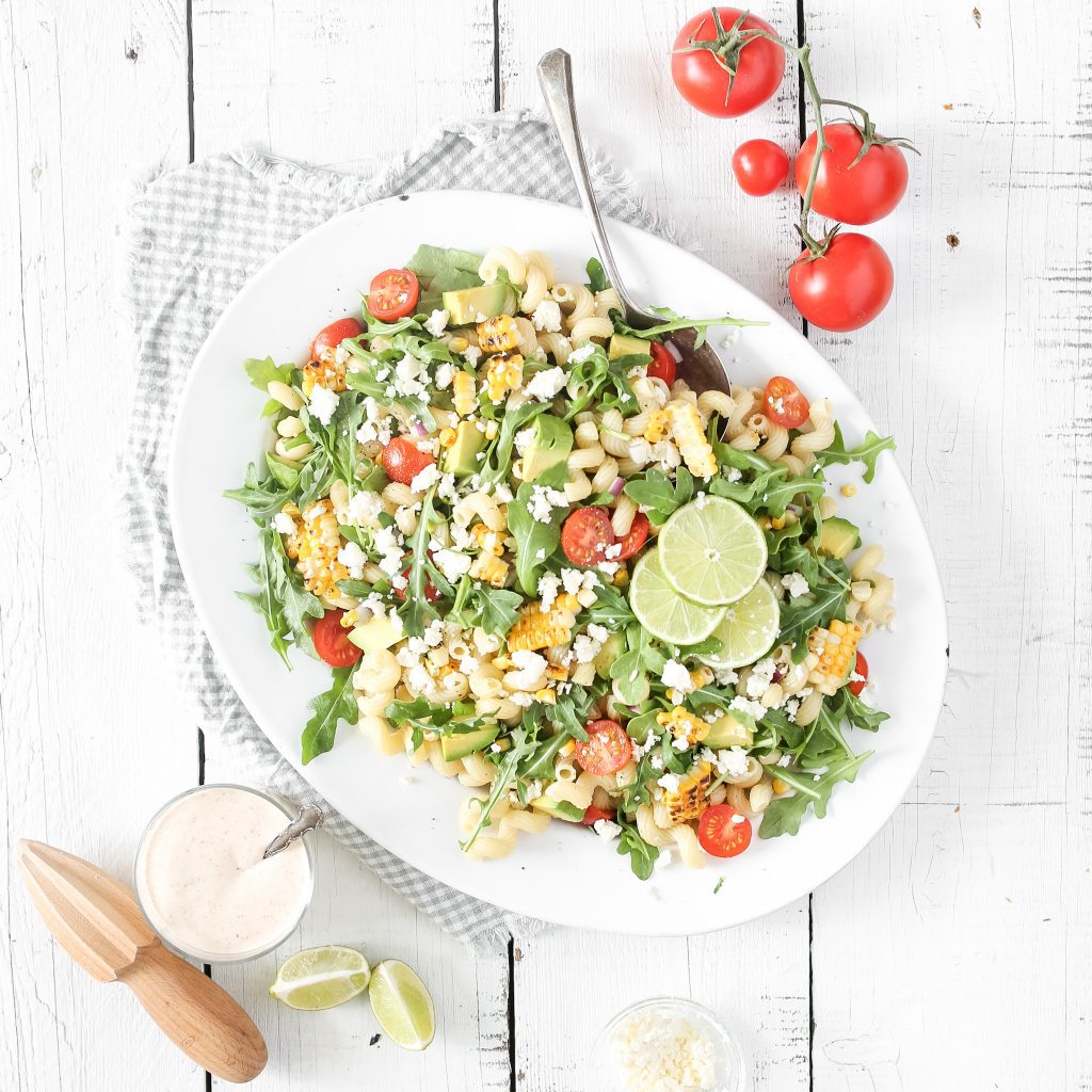 Fraiche Living Grilled Corn Pasta Salad in a bowl with lime
