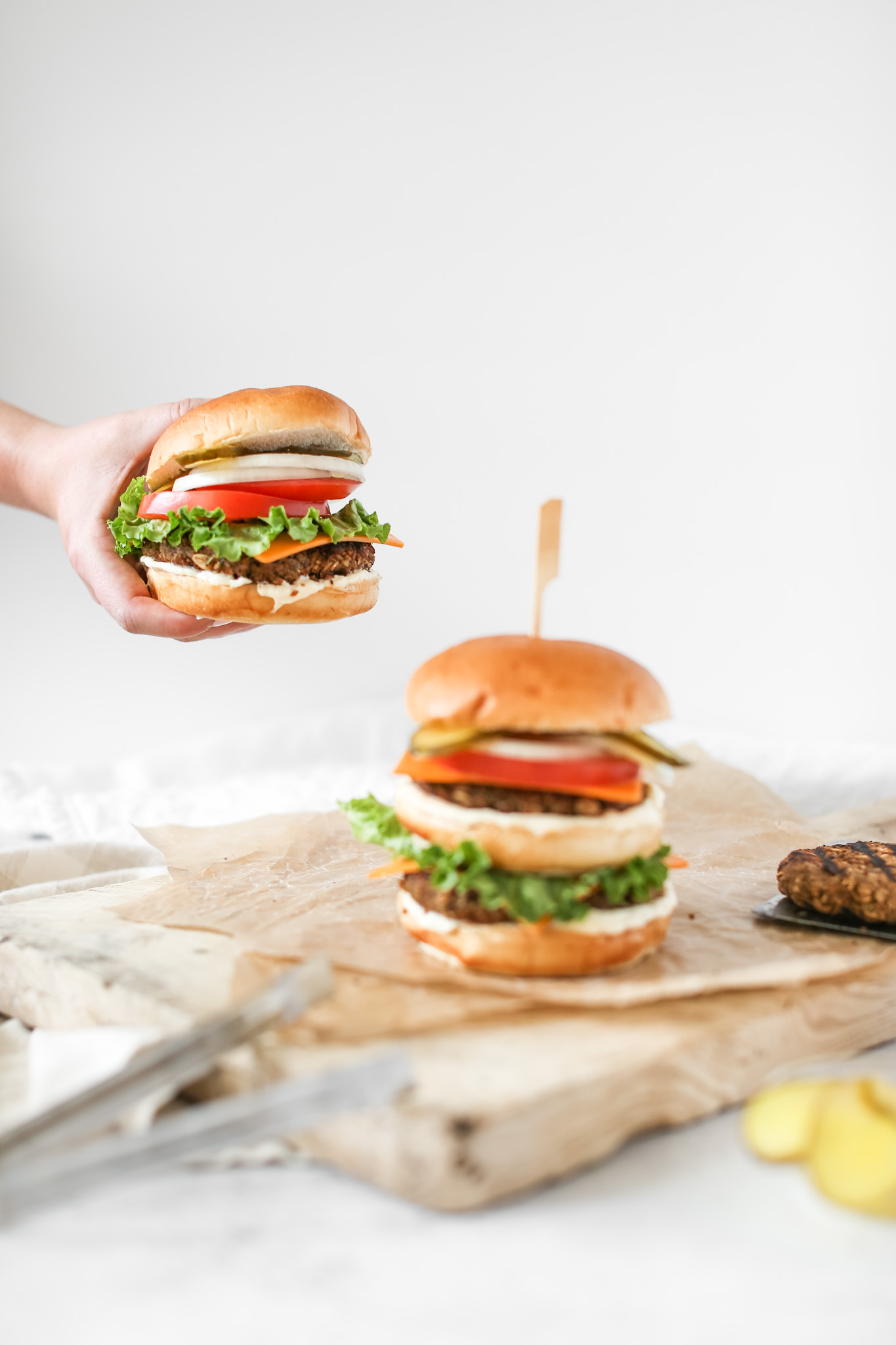 hand holding Grillable Veggie Burgers with Diner Sauce