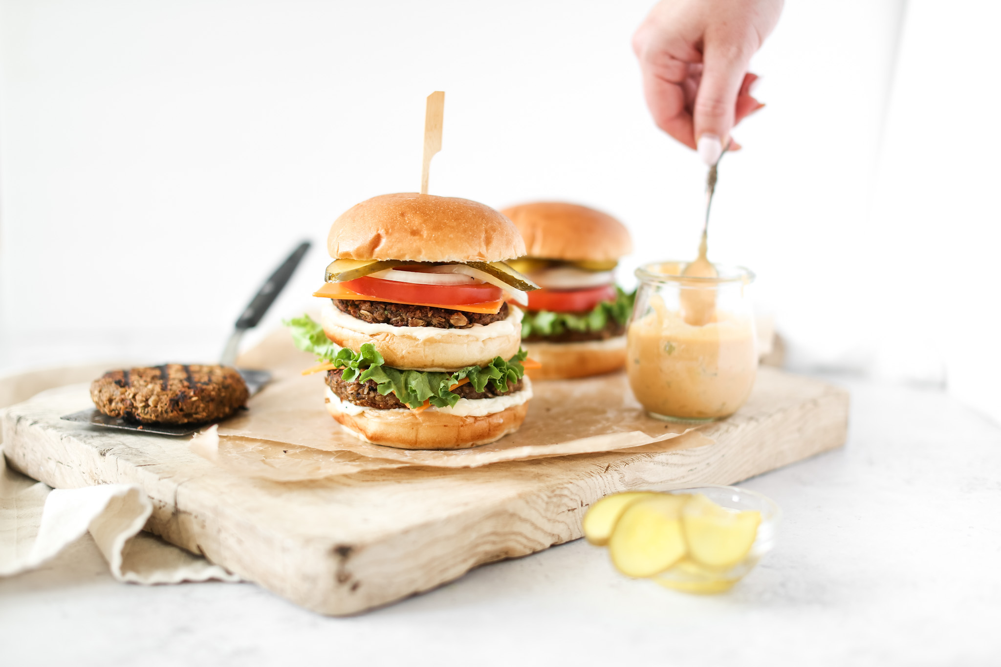 Stacked Grillable Veggie Burgers with Diner Sauce and lettuce, tomato, onions and cheese