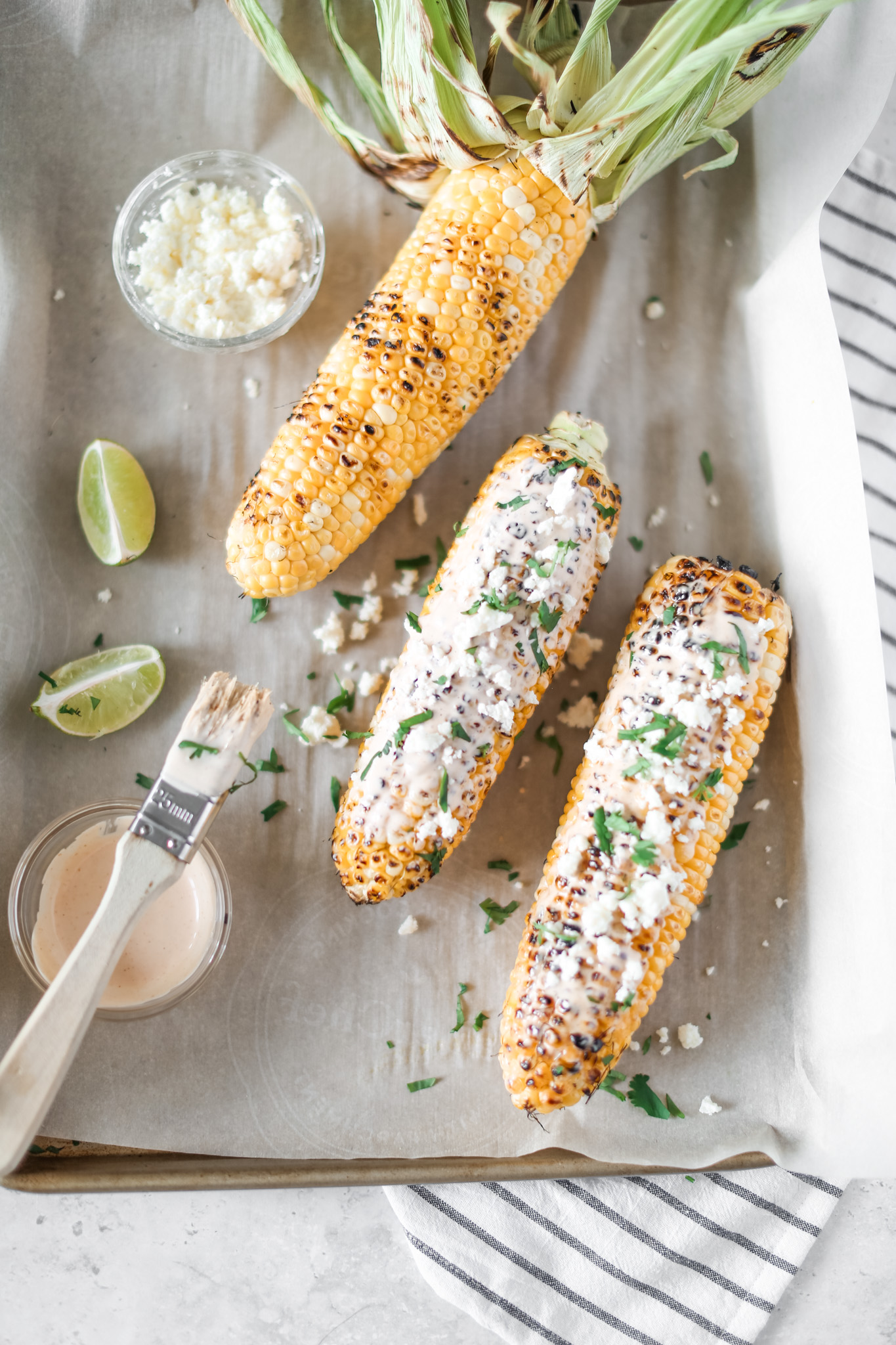 Chipotle Grilled Corn by Fraiche Living topped with feta and cilantro