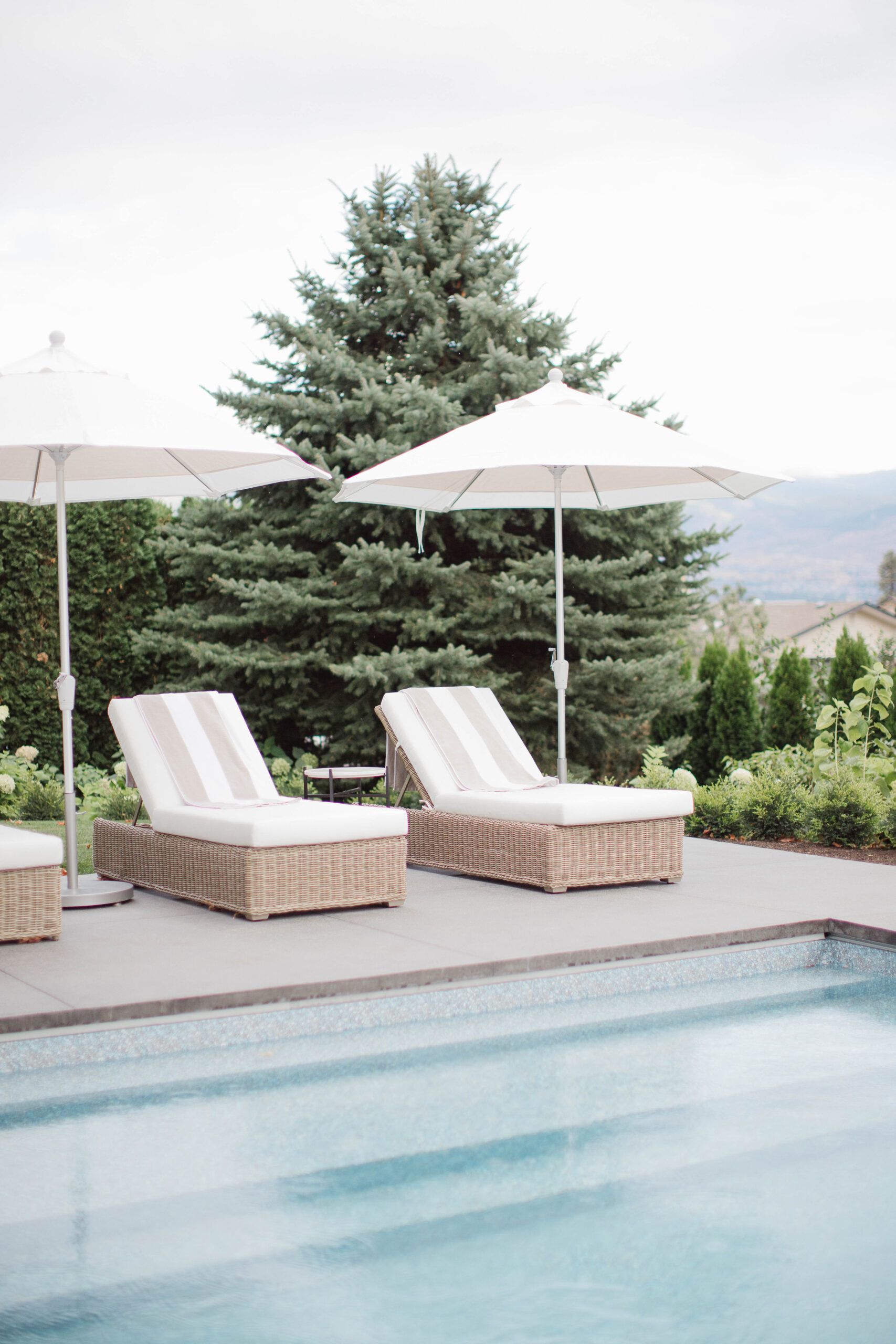 Pool Loungers with white umbrellas