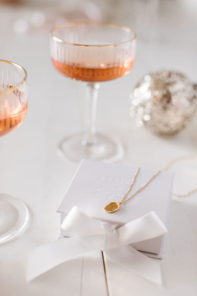 Inspire Forget Me Not pendant in gold with a glass or rosé from the New Fraîche X So Pretty Holiday Collection