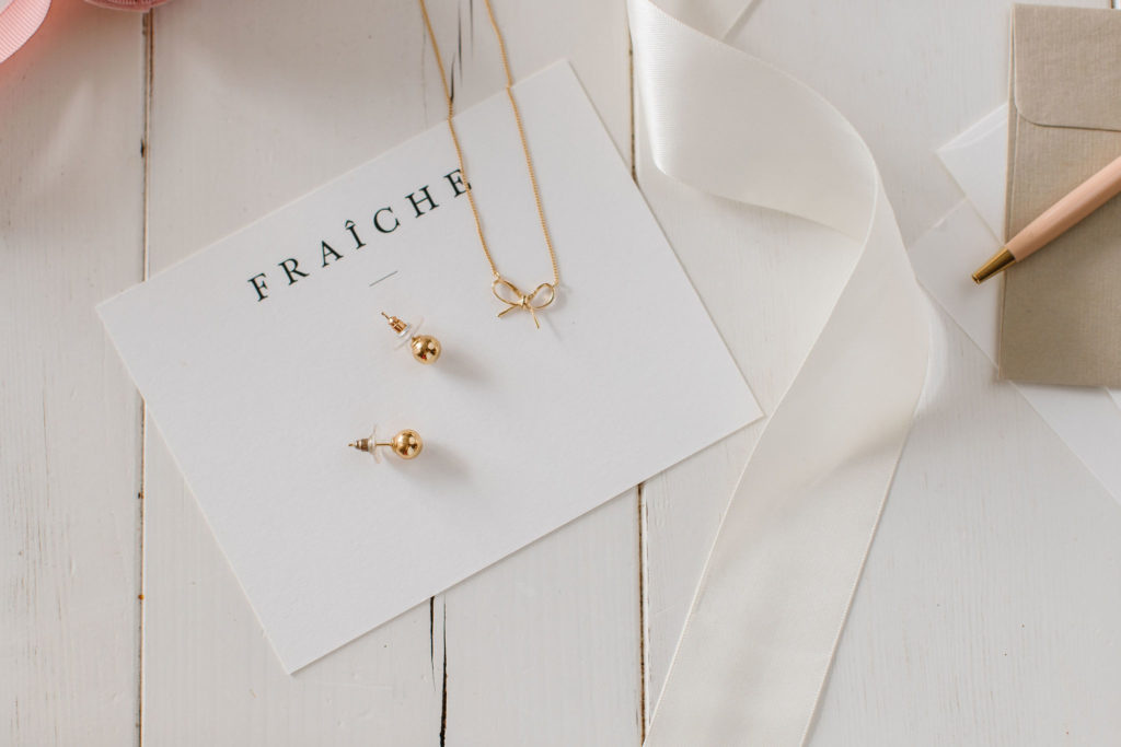 Inspire gold studs and bow necklace from the New Fraîche X So Pretty Holiday Collection