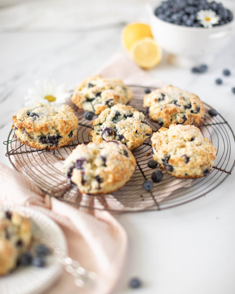 Blueberry Lemon Scones on a drying rack with berries