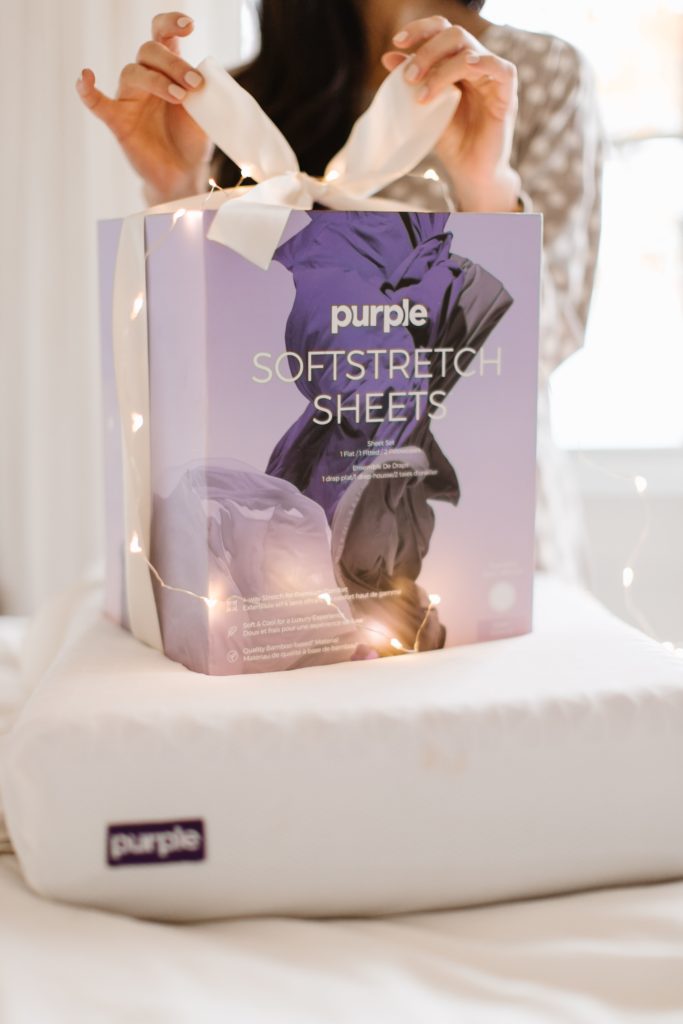 Sleep Country Purple Sheet Set box on the bed wrapped with a bow for 12 Days of Christmas Giveaways