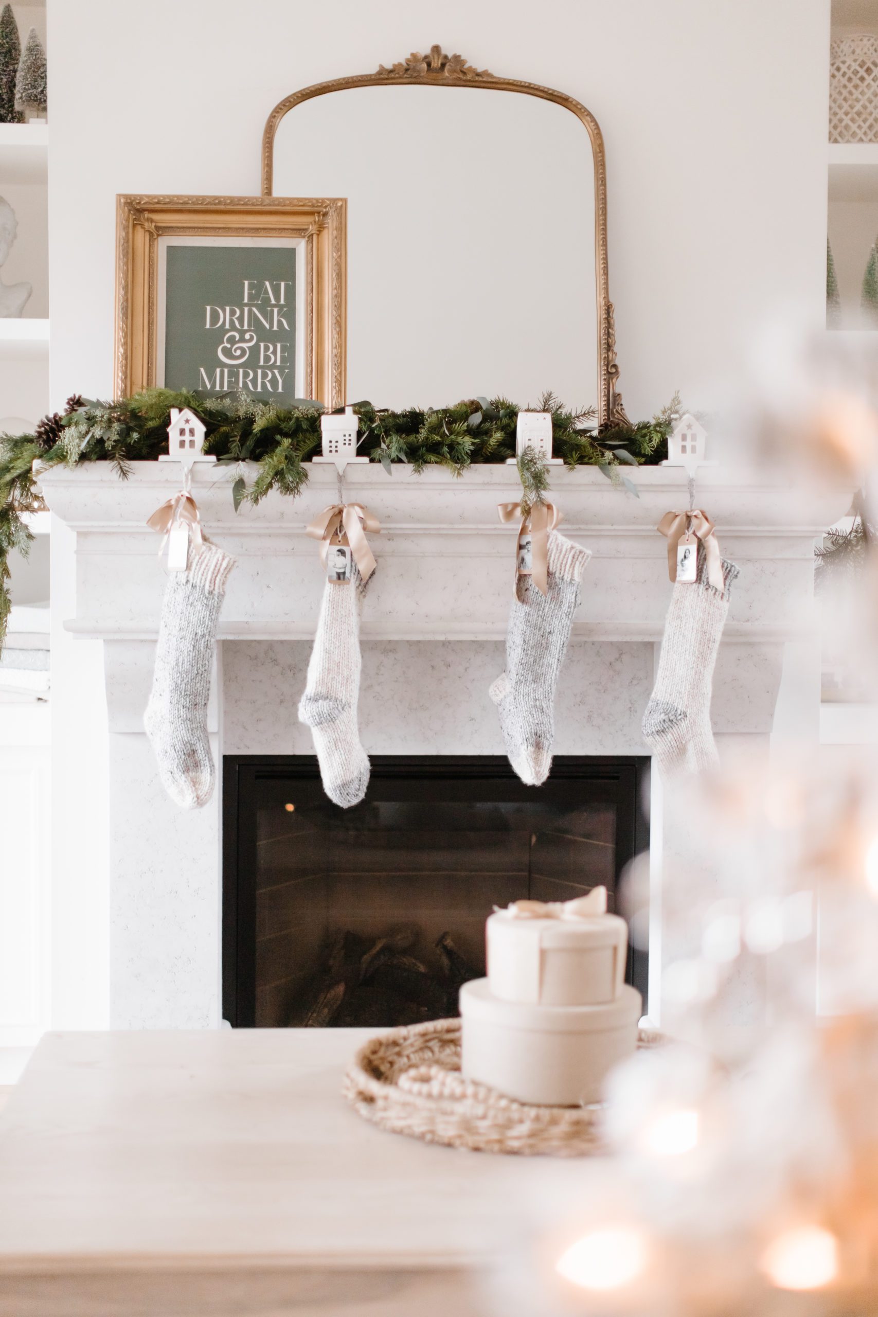 Christmas stockings tied with ribbon hanging on the mantle