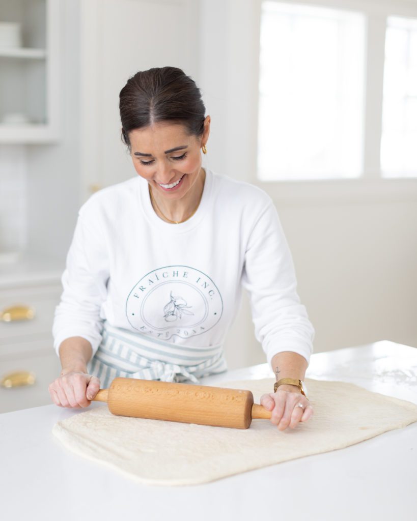 Tori rolling out dough for Cinnamon Buns